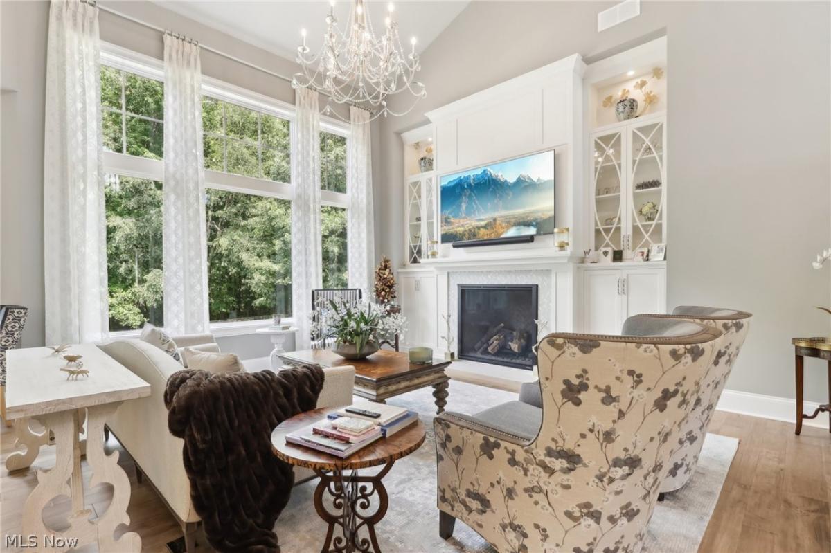 Living room with a chandelier and a fireplace.