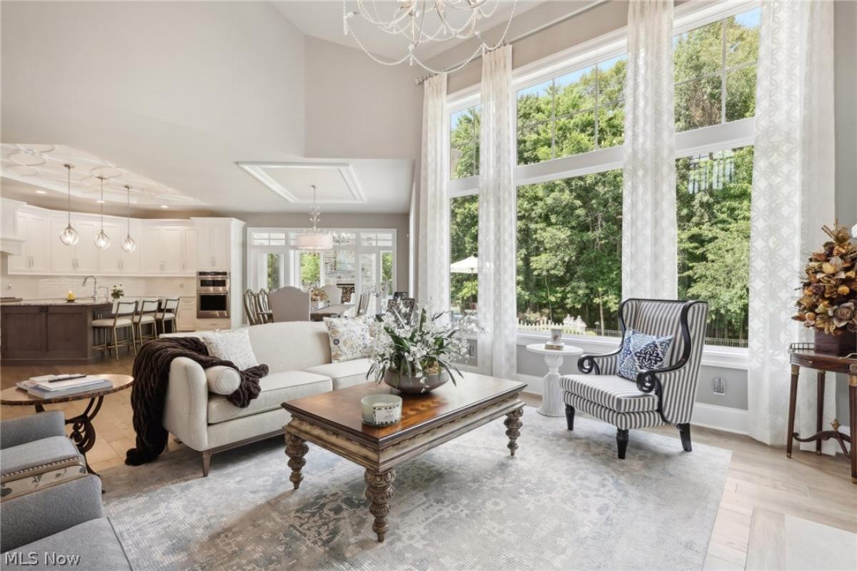Living room with couches and hardwood floors.