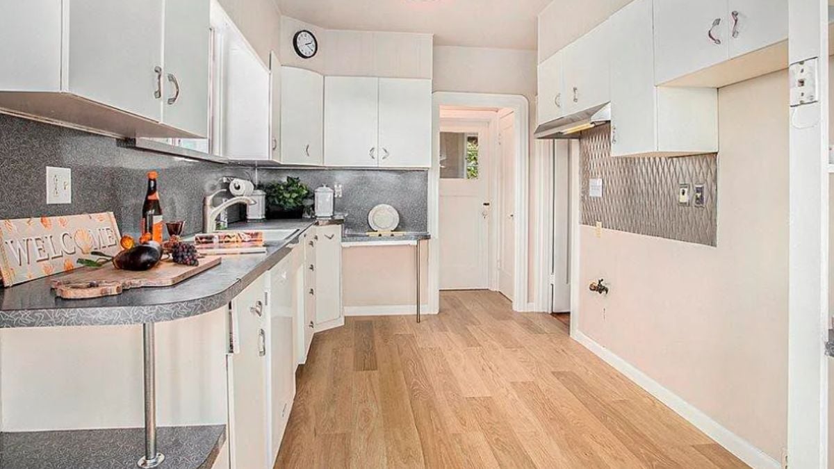 A kitchen with a countertop, cabinets, and a sink.