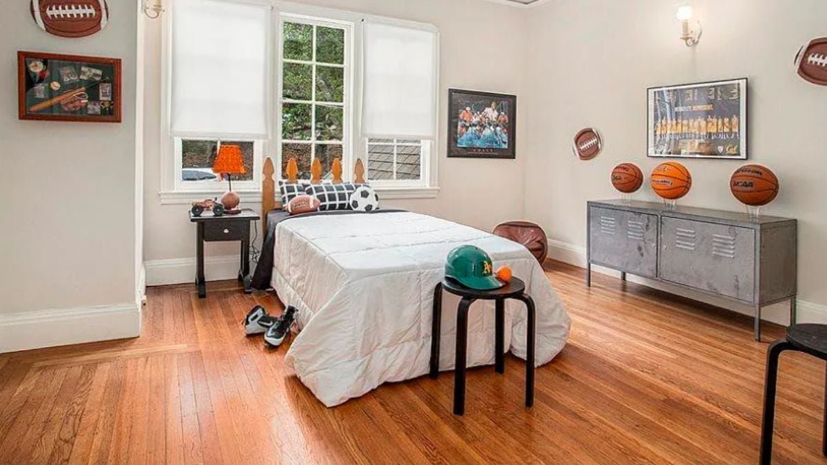 A bedroom with a bed, a cabinet, a window, and a nightstand.