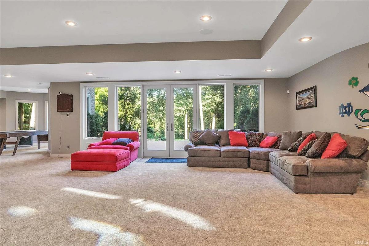 Living room with carpet flooring and couches.