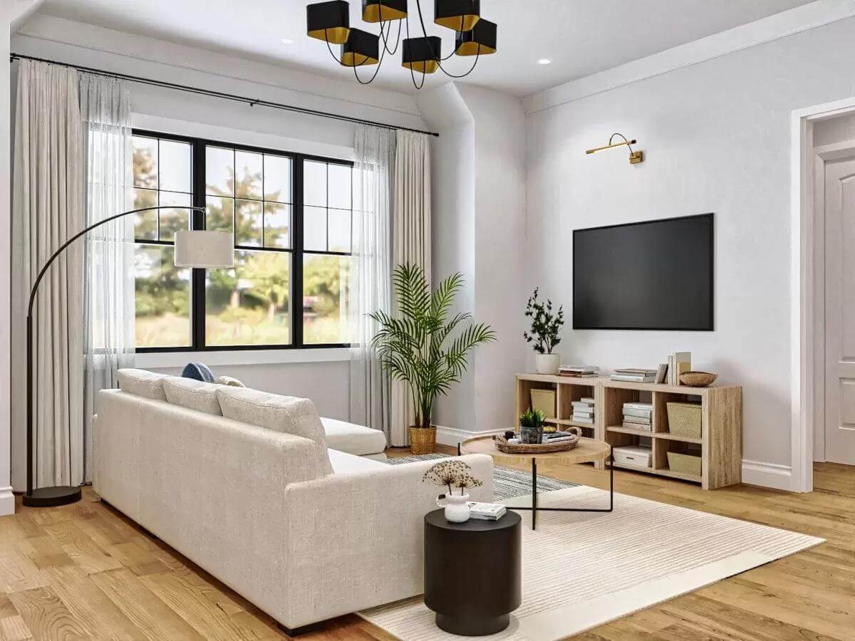 Living room with a gray sofa and a wall-mounted TV.