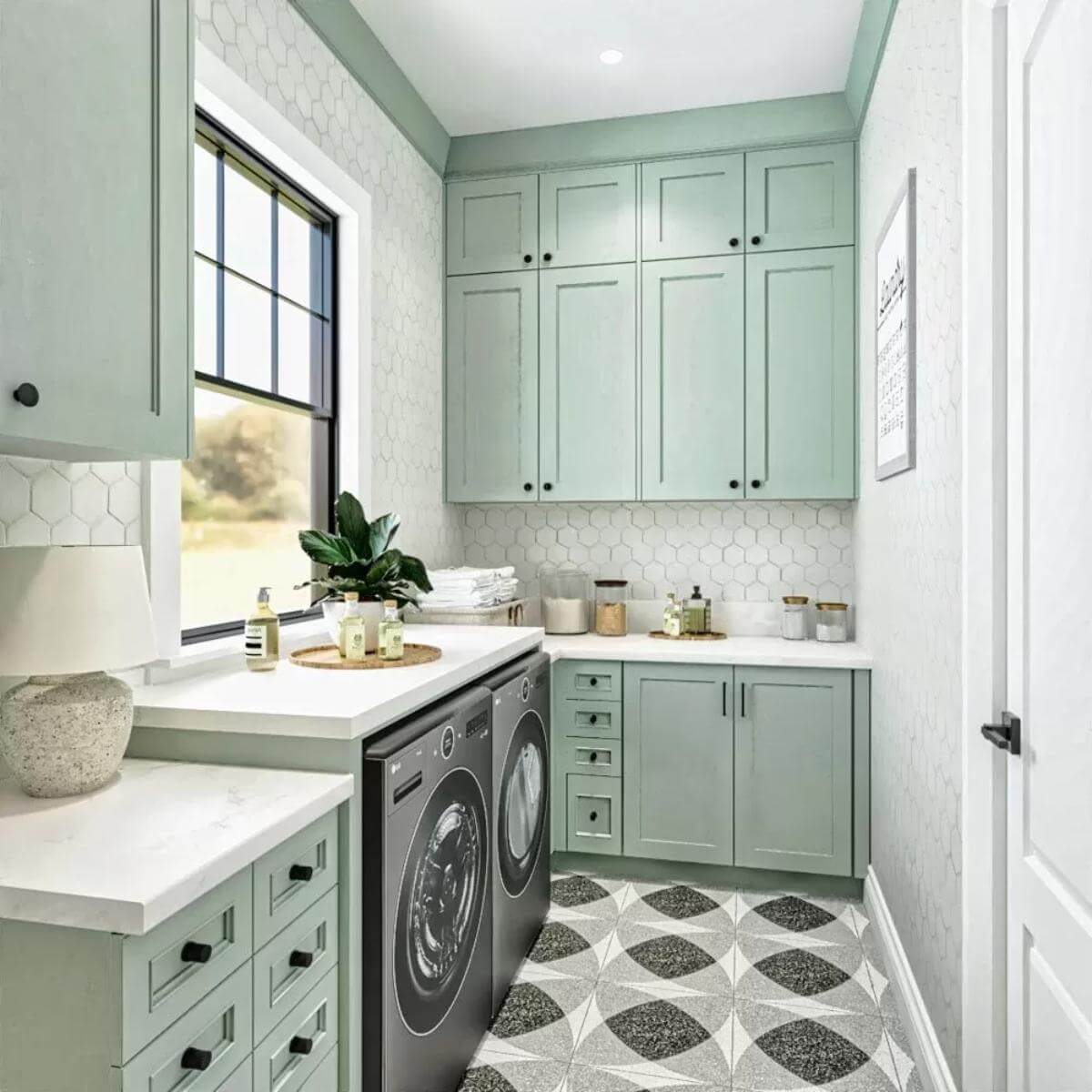 Laundry room with mint green cabinets and front-load appliances.