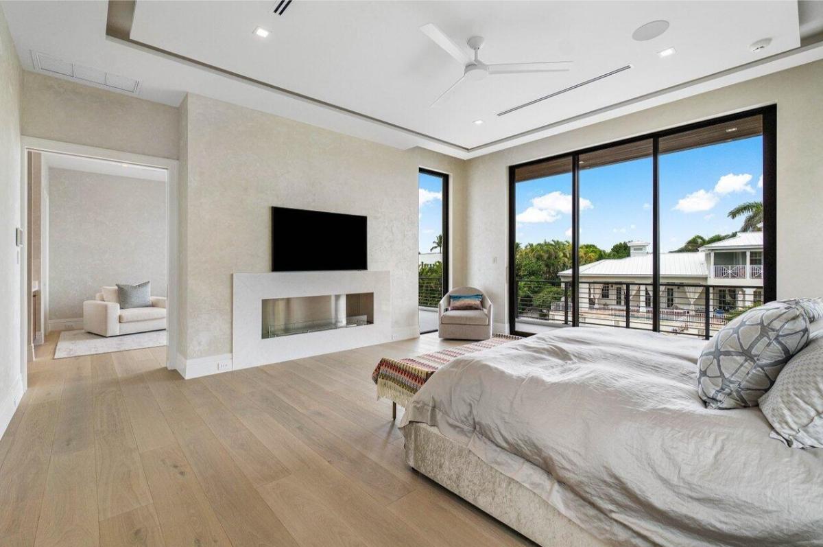 Bedroom with hardwood floors and a private living space.