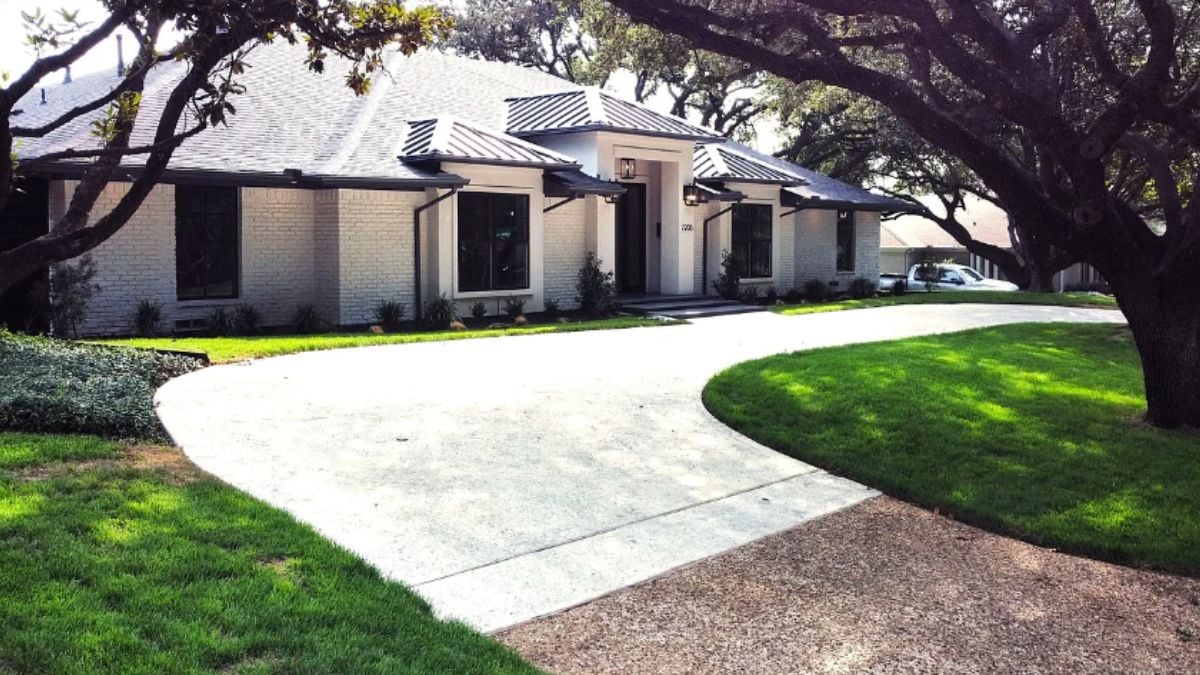 A courtyard with trees and grass in the center.