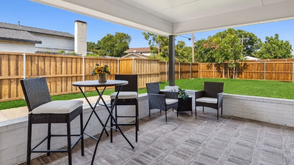 A porch with chairs and coffee table.