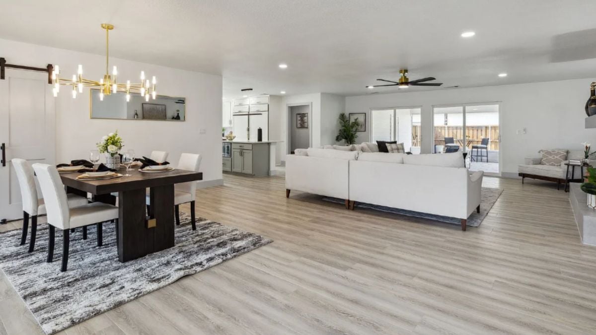 A great room with a dining area, a living area, and a kitchen.