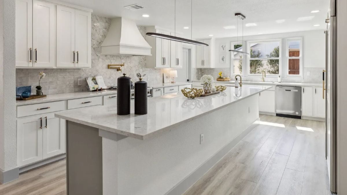 A kitchen with a center island, countertops, cabinets, and kitchen appliances.
