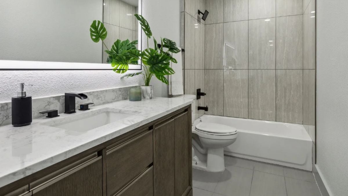 A bathroom with a vanity, a toilet, and a bathtub.