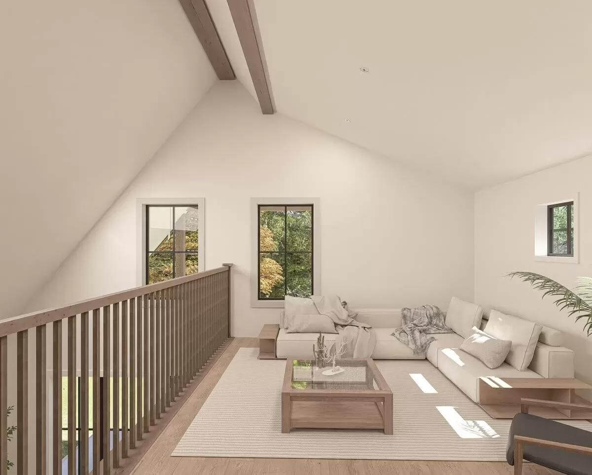 Loft with a vaulted ceiling and a wooden railing.