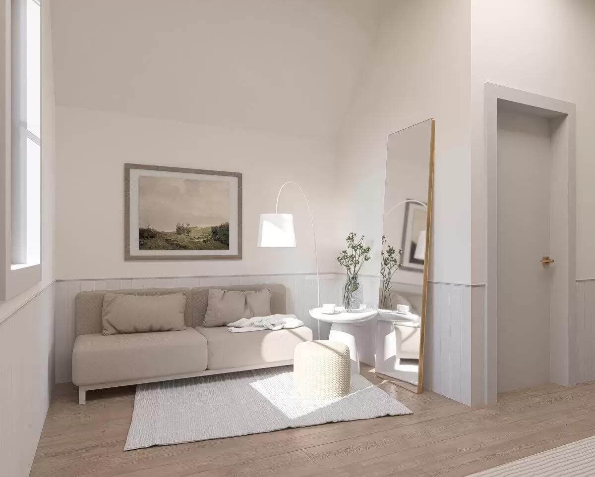 Sitting area with a modern sofa and a full-length mirror.