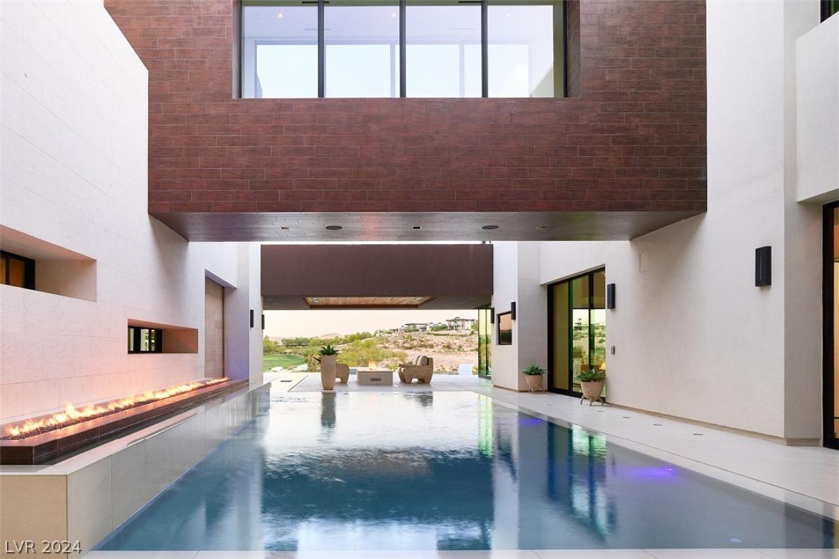 Indoor pool with a fire pit.