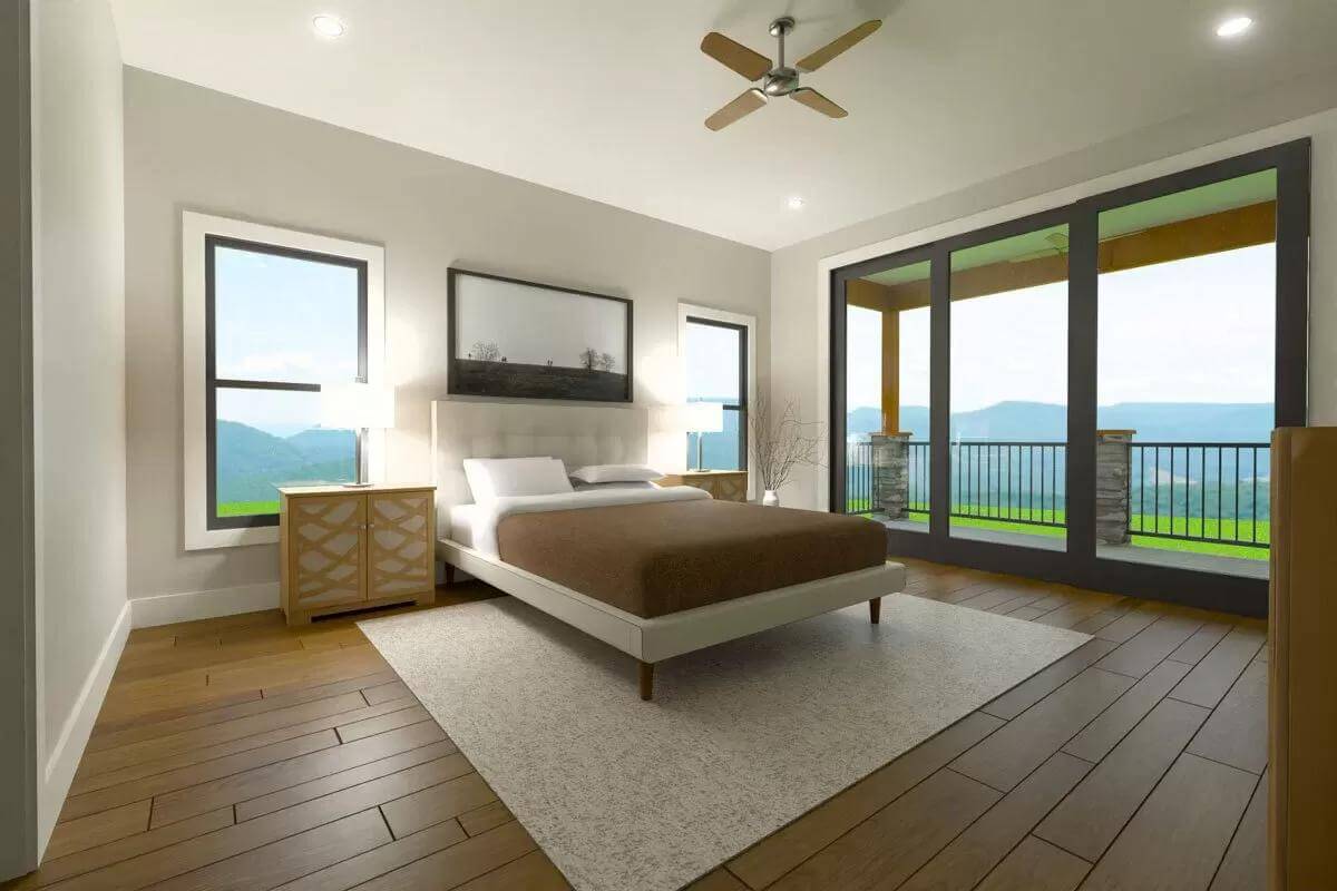 Primary bedroom with a tufted bed and sliding glass doors that open to a covered balcony.