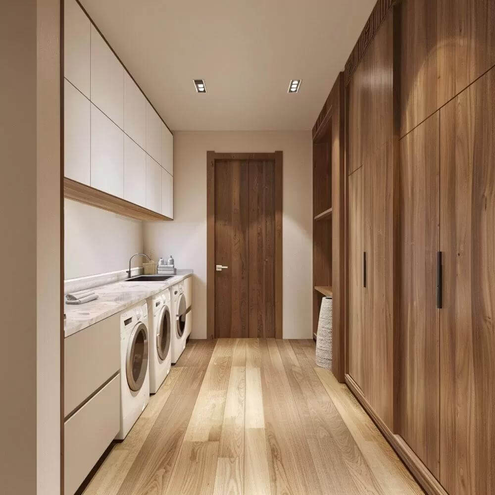 Laundry room with floor-to-ceiling cabinets, a marble countertop, and a utility sink.