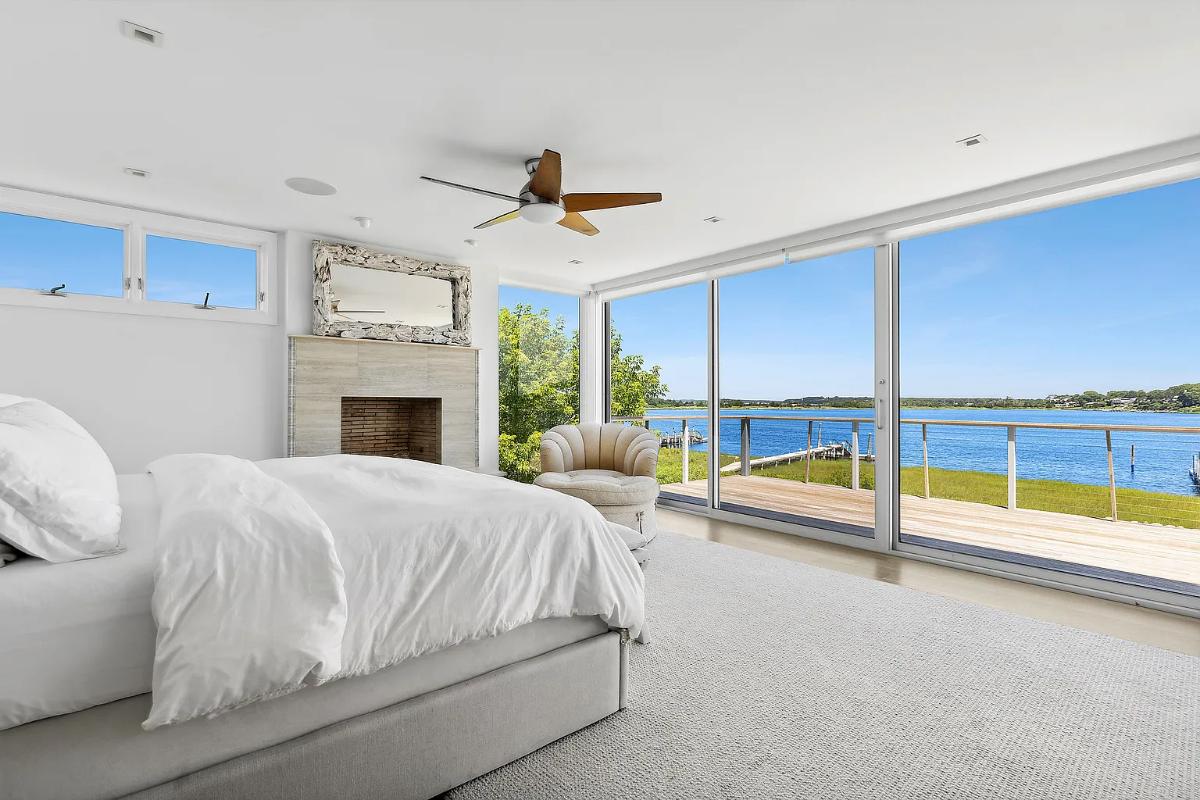 Bedroom with a fireplace and sliding glass doors.