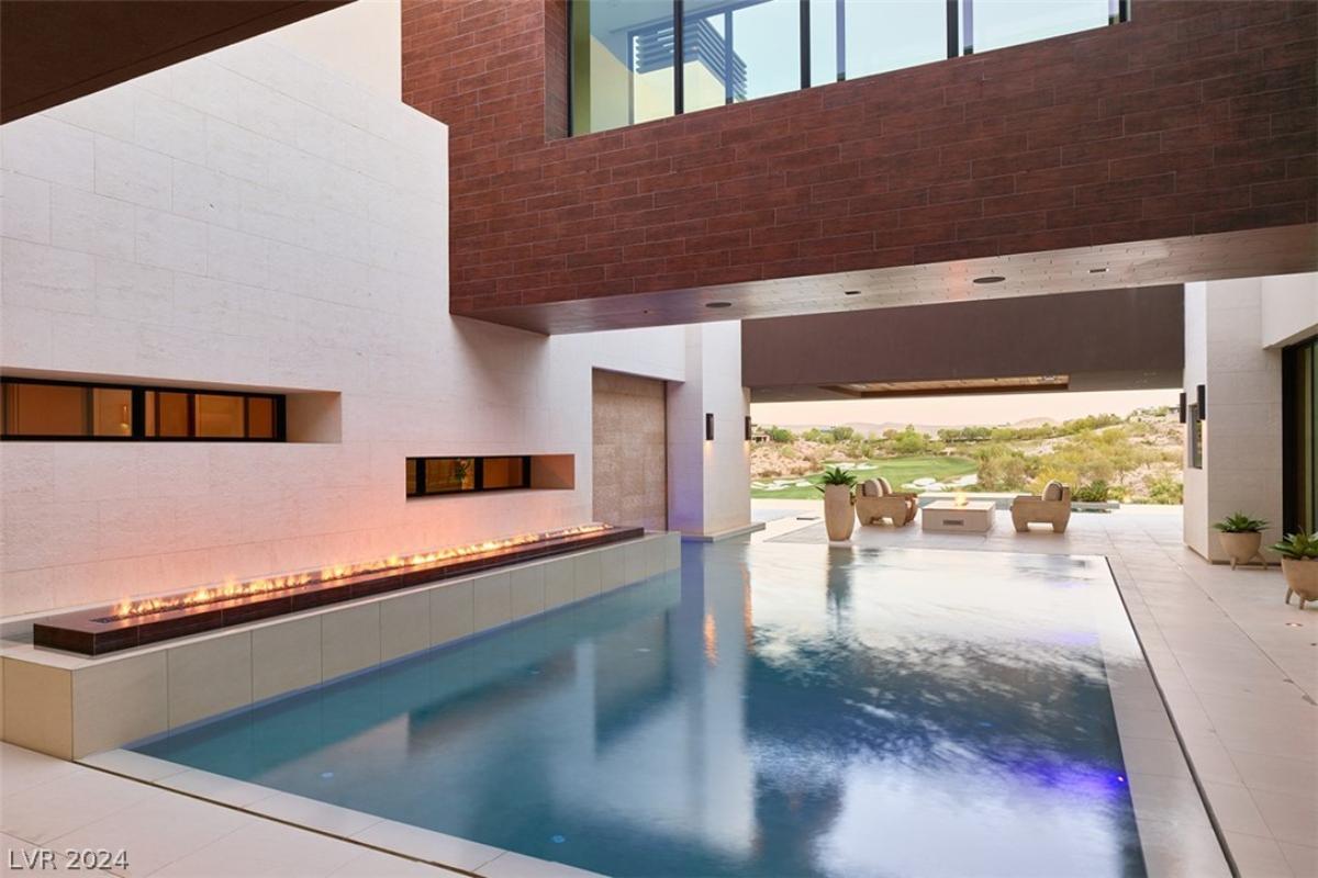 Indoor pool with a fire pit.