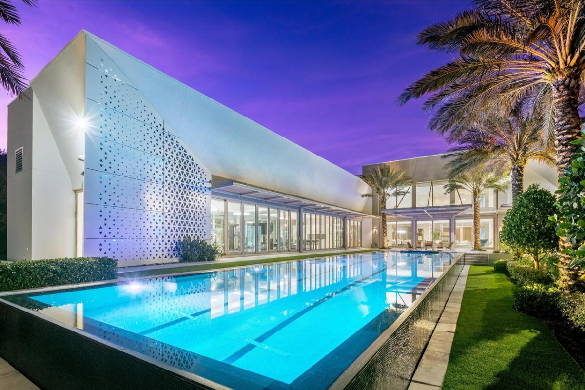 Rear view of the mansion with a pool.
