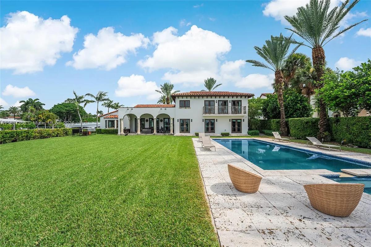 Rear view of the mansion with a pool.