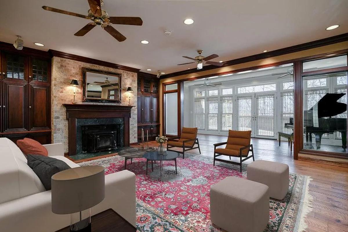 Living room with hardwood flooring and a fireplace.