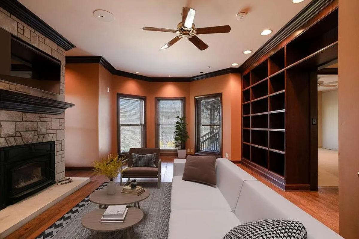 Living room with hardwood flooring and a fireplace.