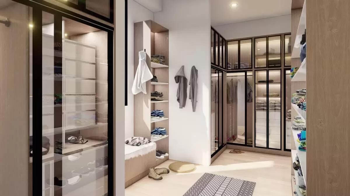 Primary walk-in closet with ample storage and a hardwood floor.