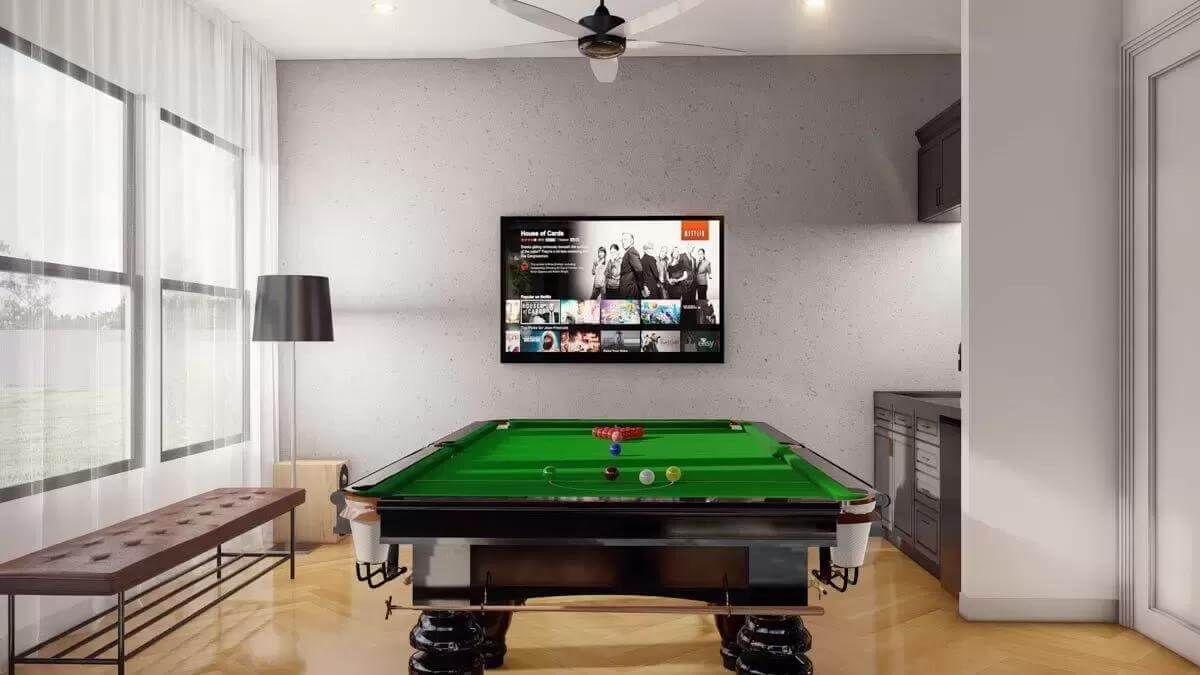 Game room with a billiards table, a large TV, and a wet bar.