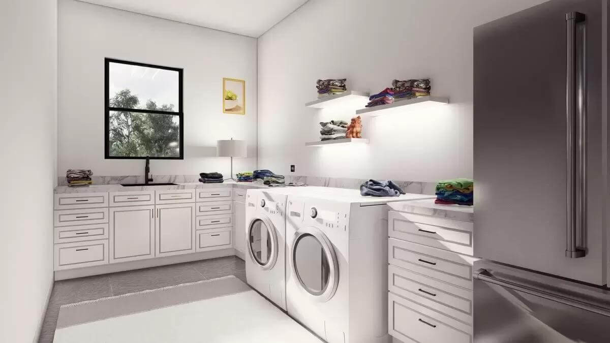 Laundry room with white cabinets, a fridge, and a utility sink.