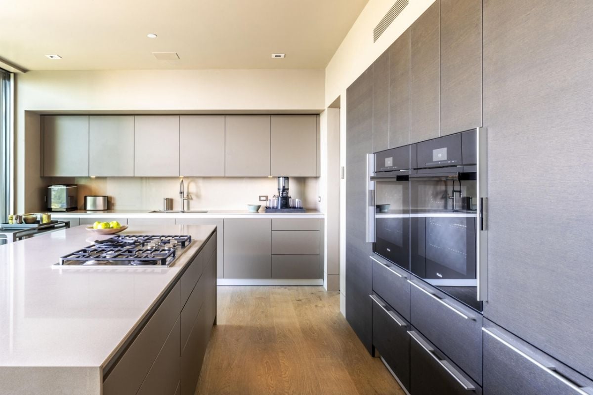 A kitchen with countertops, a sink, cabinets, and kitchen appliances.
