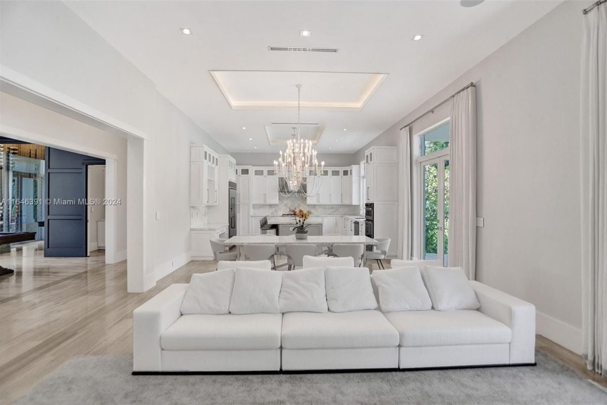 A great room with living space, a dining area, and a kitchen.