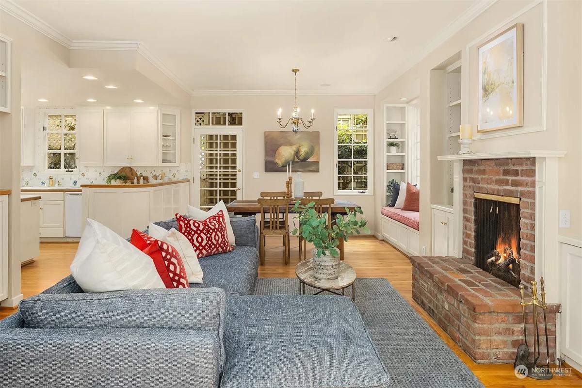 Living room with couches and a fireplace.