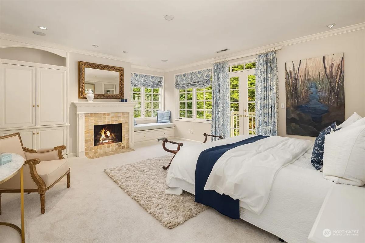 Bedroom with carpet flooring and a fireplace.