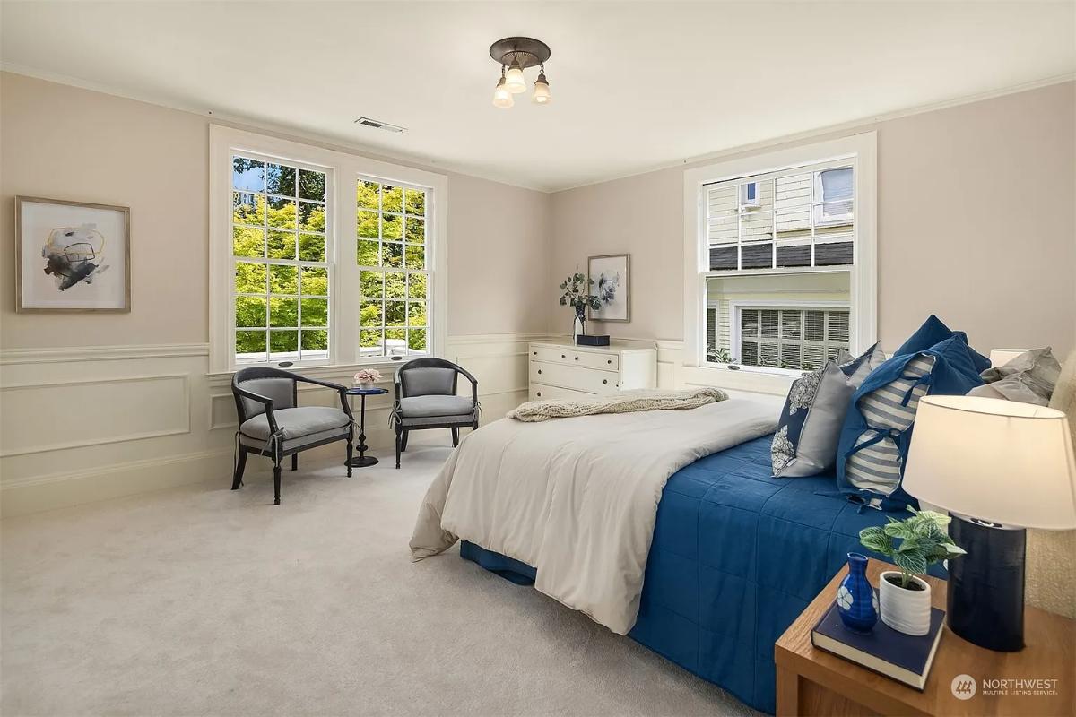 Bedroom with carpet flooring and glass windows.