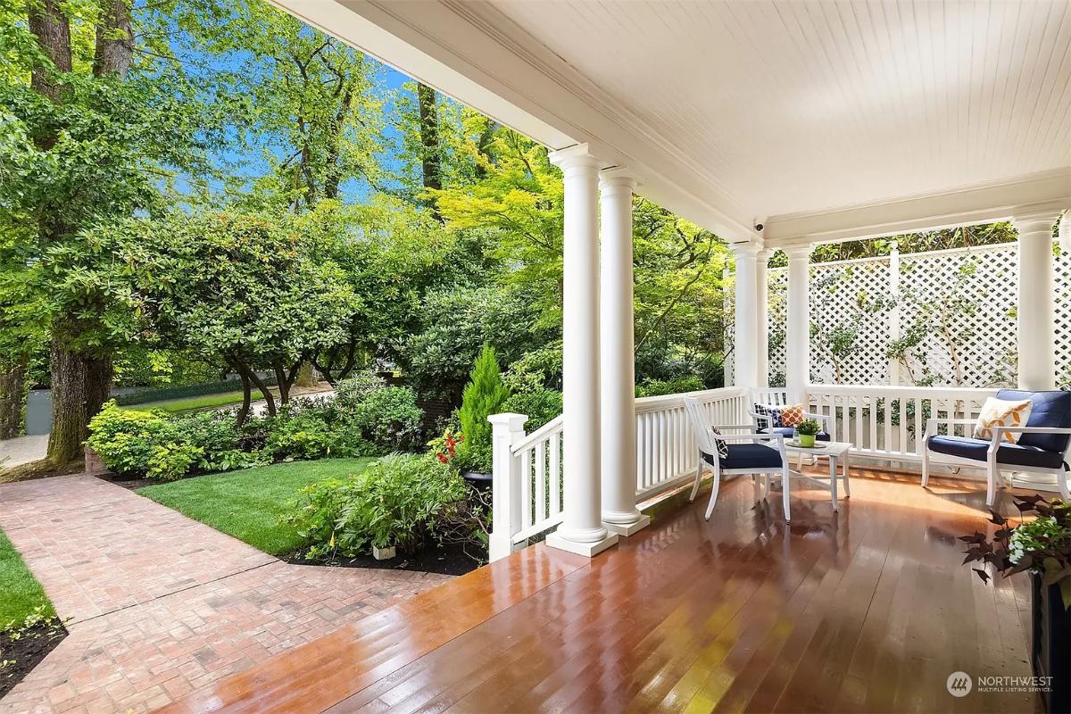 Porch with a table and chairs.