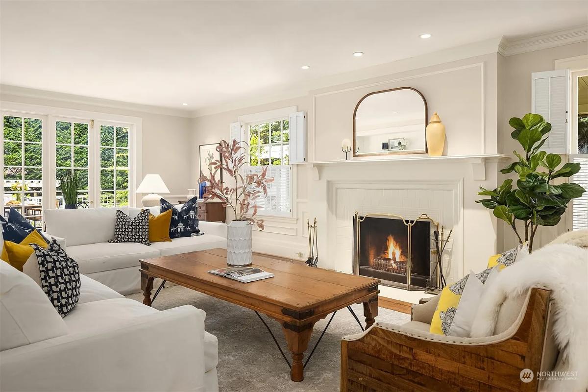 Living room with couches and a fireplace.