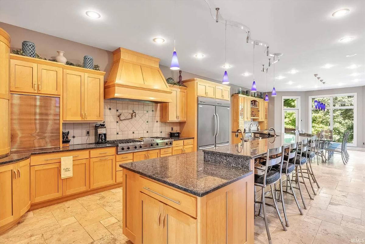 Kitchen with custom cabinetry and a counter breakfast bar.