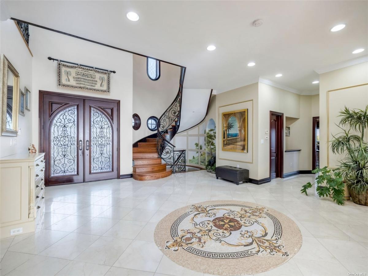 Foyer with tile flooring and custom lighting.