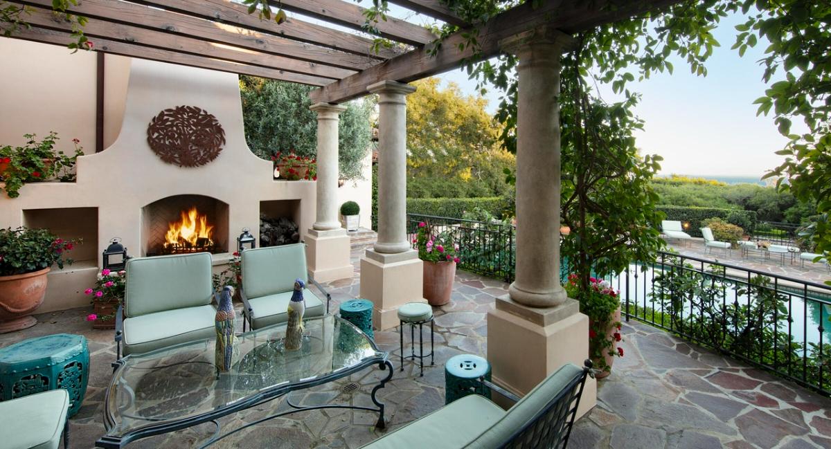 Outdoor living space with a fireplace.