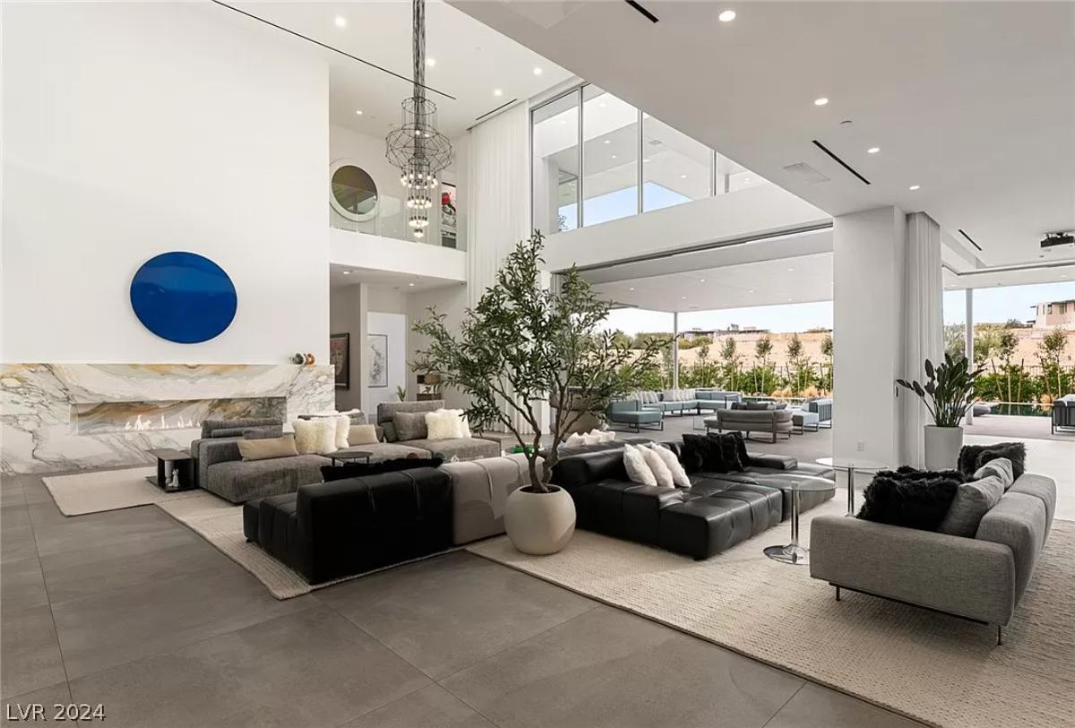 Living room with couches and a fireplace.