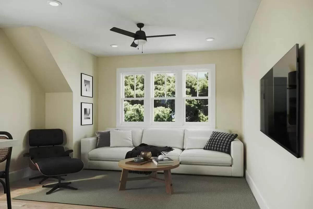 Living area with a sectional sofa, a lounge chair, and a wall-mounted TV.