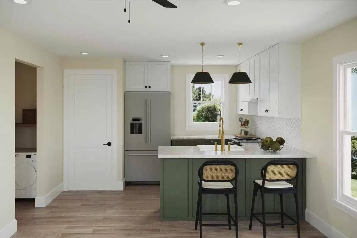 Kitchen with white cabinets, slate appliances, and a peninsula bar with seating for two.