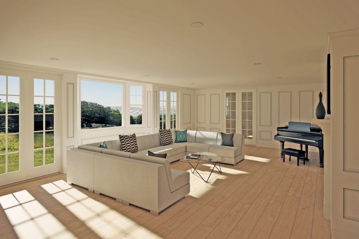 A living room with windows, a white couch, a glass center table, and a piano.