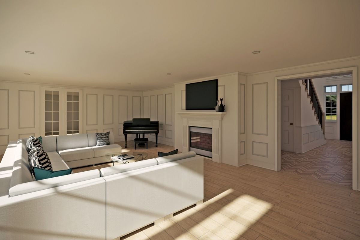 A living room with a fireplace, a white couch, a glass center table, a TV, and a piano.