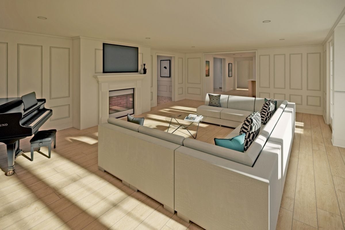 A living room with a fireplace, a white couch, a glass center table, a TV, and a piano.