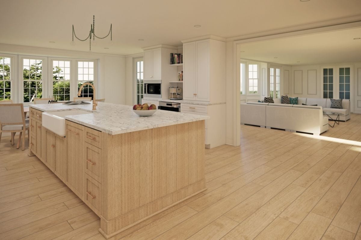 A kitchen with windows, countertops, a sink, and cabinets.