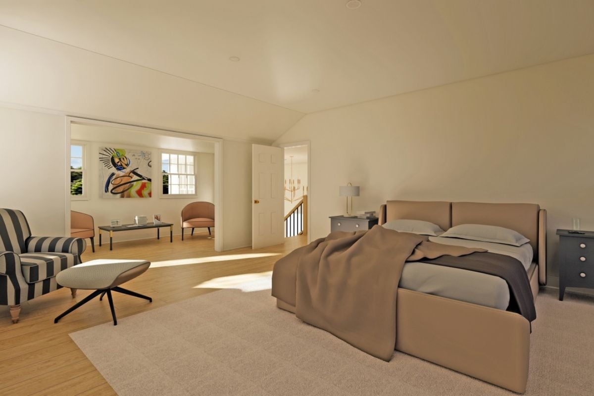 A bedroom with a bed, a rug, a nightstand, windows, a TV, a fireplace, a chairs, and a coffee table.
