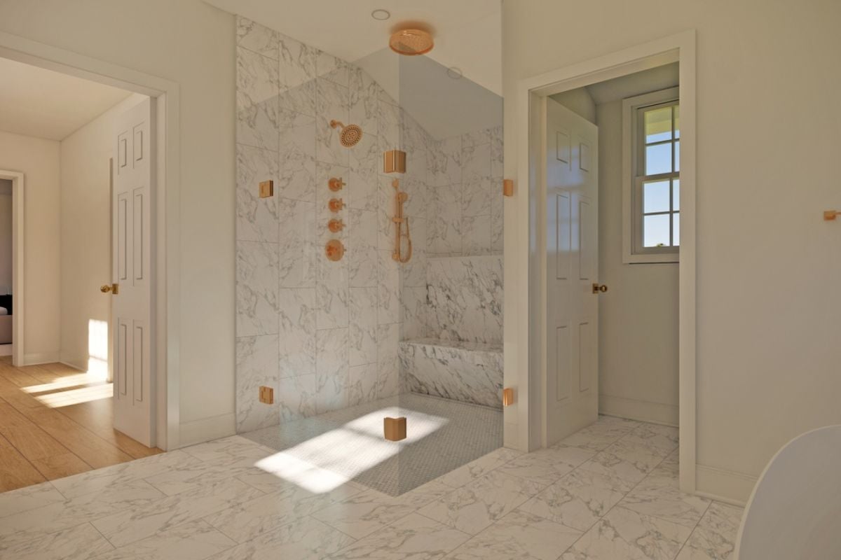 A bathroom with a tiled floor and a separate shower room.