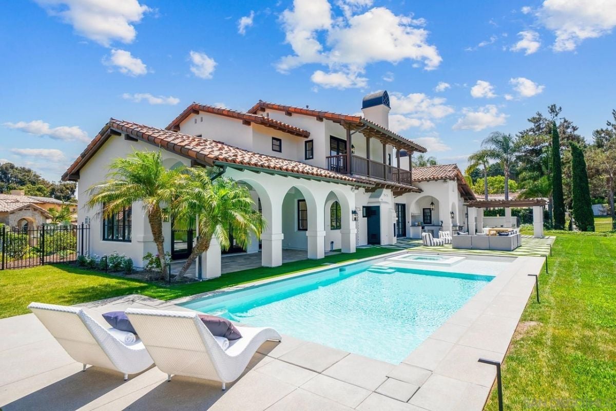 A swimming pool with a jacuzzi and a comfy chair.