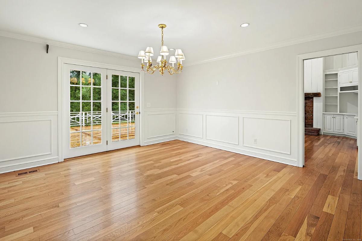 Dining room with hardwood floors and a chandelier.