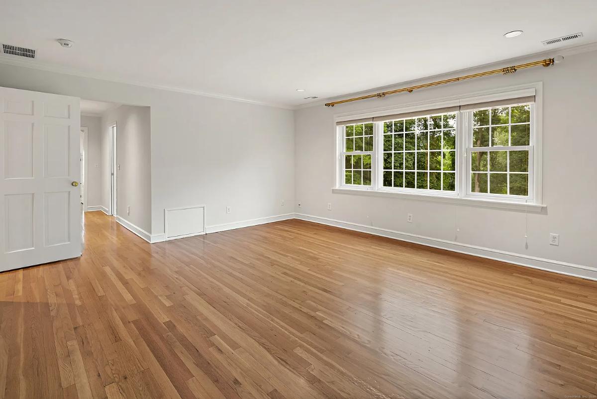 Bedroom with hardwood flooring.
