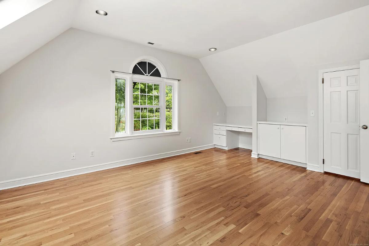 Bedroom with hardwood flooring.